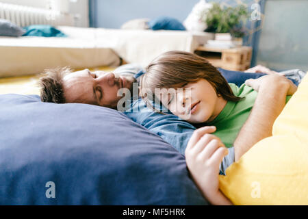 Father and son sleeping at home Stock Photo
