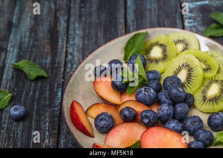 Plate with blueberries and slices of kiwi and nectarine Stock Photo