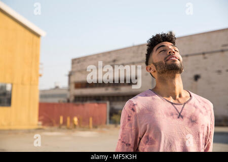 Young man outdoors leaning back Stock Photo