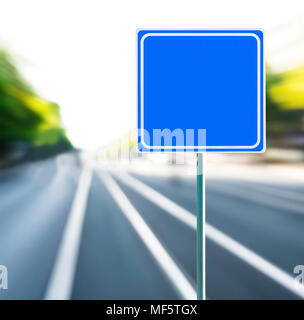 Template, blank, clean blue road sign with blurred speedy background. Copy space. Stock Photo