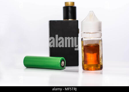personal vaporizer with battery and q juice or e liquid, green battery and  black e ciggaretes with liquid isolated in white background Stock Photo
