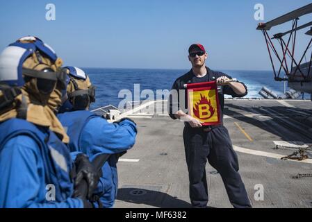 180416-N-DO281-0060 RED SEA (April 16, 2018) Hull Technician 2nd Class Kristofer Woods simulates a fire during a helicopter crash and smash drill aboard the guided-missile cruiser USS Monterey (CG 61), April 16, 2018. Monterey is deployed to the U.S. 5th Fleet area of operations in support of maritime security operations to reassure allies and partners and preserve the freedom of navigation and the free flow of commerce in the region. (U.S. Navy photo by Mass Communication Specialist Seaman Trey Fowler). () Stock Photo