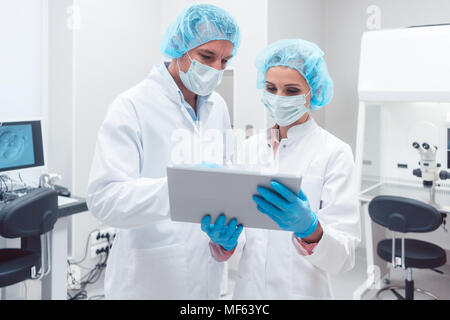Two scientists working together in lab looking at data Stock Photo