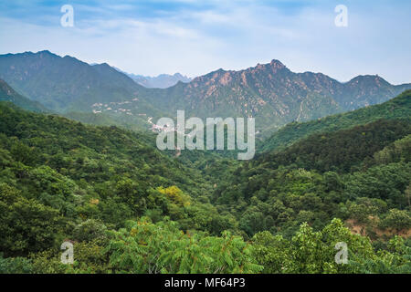 Mountain landscape seen from the majestic Great Wall. Stock Photo