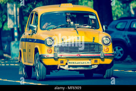 Kolkata, India - March 11th 2018: Iconic yellow taxi in Calcutta ( Kolkata ) India. The Ambassador taxi is no more built by Hindustan Motors but thous Stock Photo