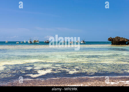 Several fishing boats moored off the coast at low tide, Watamu, Kenya Stock Photo