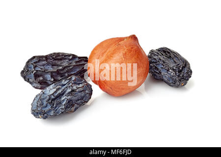 Black raisins and hazelnuts on white Stock Photo