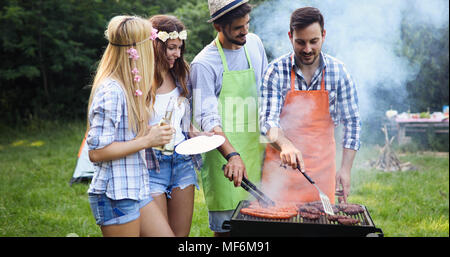 Happy friends enjoying barbecue party Stock Photo