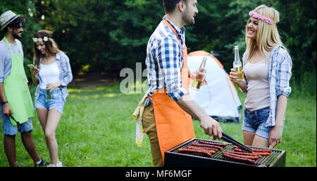 Happy friends enjoying barbecue party Stock Photo