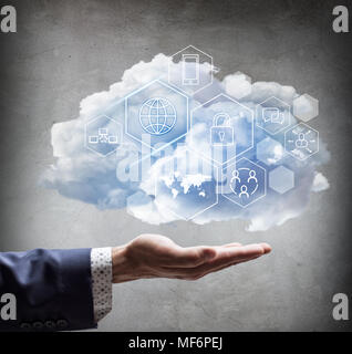 Hand holding cloud with different digital icons. Stock Photo