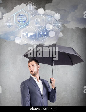 Businessman holding cloud with different digital icons. Stock Photo
