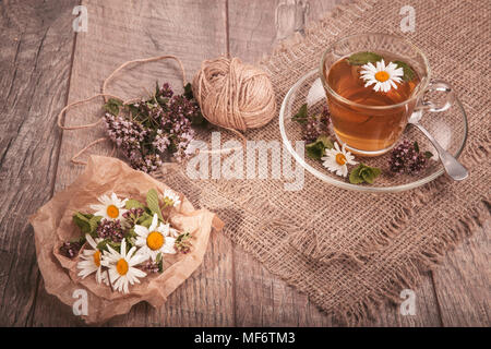 Cup of medicinal chamomile tea on a wooden Stock Photo