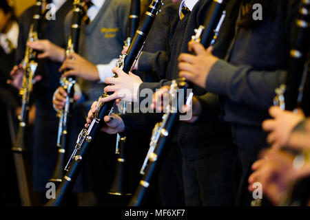 children in school and classroom setting learning to play musical instruments Stock Photo
