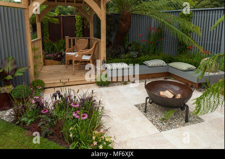 Seating areas, gazebo, patio fire pit & flowers in tropical style show garden - Visit Plantation: Colonial Chic and Bajan Roots. RHS Show Tatton Park. Stock Photo