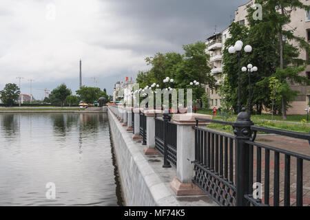 Yekaterinburg, Russia - June,21,2017: Embankment of the city pond with view of unfinished TV tower in summer day. Stock Photo