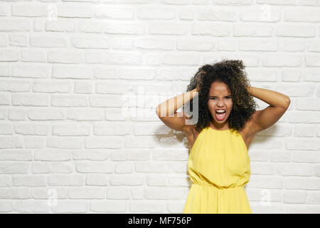 Face, fear and worried with a black woman in studio isolated on a
