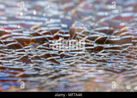 Abstract background: broken tempered glass texture. Selective focus, High angle view. Stock Photo