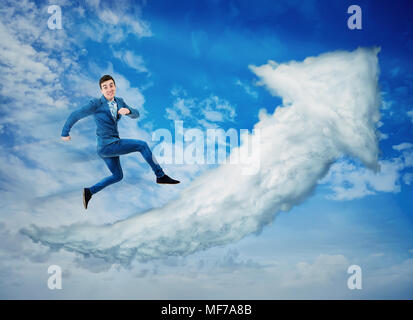 Surreal view as a happy businessman jump on a cloud graph arrow going up over a blue sky background. No limits success concept, business metaphor as k Stock Photo