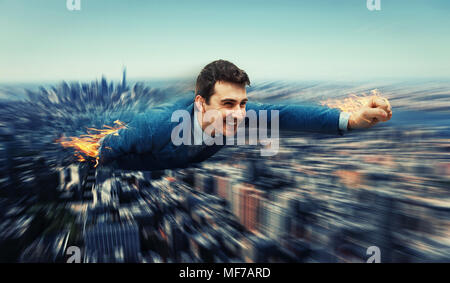 Happy, smiling businessman flying over the city skyscapers like a superhero. Huge speed with motion blur and his ands and legs on fire. Business fast  Stock Photo