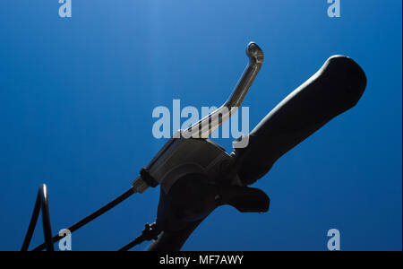 Detail of the bicycle brake and handle part. On the background is blue sky. Stock Photo