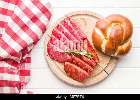 Slices of chorizo salami sausage on cutting board. Stock Photo