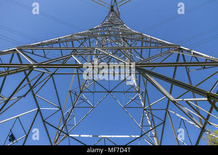 Low angle symmetrical view, from below, of an electricity pylon in the UK Stock Photo
