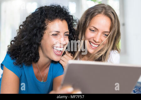 Two happy women looking at tablet Stock Photo