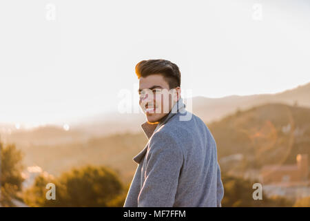 Portrait of smiling young man at sunset Stock Photo