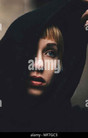 Portrait of woman with black hood Stock Photo