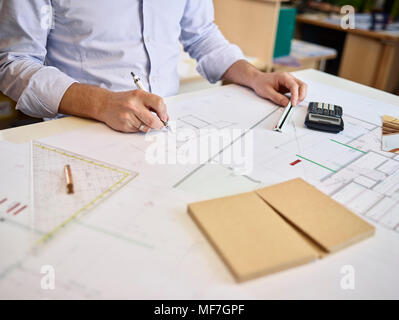 Architect working on construction drawing Stock Photo