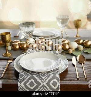 golden chicken eggs on decorated easter table Stock Photo