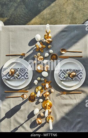 top view of easter eggs and candles on festive table in restaurant Stock Photo
