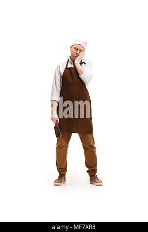 Bored butcher posing with a cleaver isolated on white background Stock Photo
