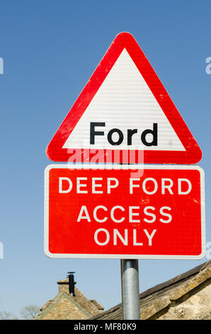 Sign warning of deep ford across the River Eye in the pretty Cotswold village of Upper Slaughter in Gloucestershire,UK Stock Photo