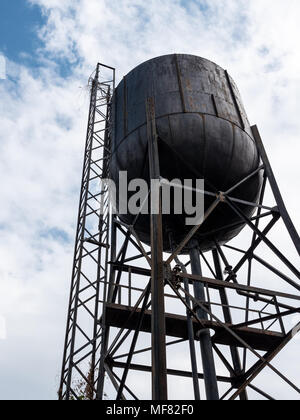 Old large water tank for use in the train station under the clear blue sky. Stock Photo