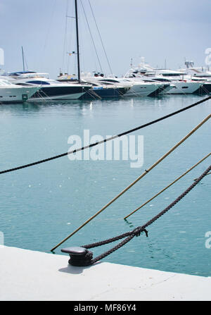 PUERTO PORTALS, MALLORCA, SPAIN - APRIL 24, 2018: Luxury yachts moored in the marina of Puerto Portals on an overcast day on April 24, 2018 in Mallorc Stock Photo