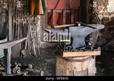 Tools on an Iron Anvil in an old Blacksmiths Shop Stock Photo