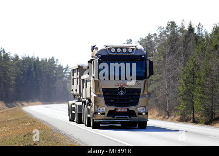 Gold Mercedes-Benz Arocs Snappertuna gravel hauler of Firma K Holmstrom on spring highway on a workday in Raasepori, Finland - April 20, 2018. Stock Photo