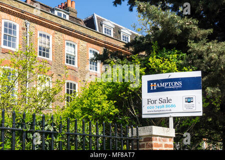 A Hamptons International estate agents For Sale signboard outside homes on Clapham Common North Side in Lambeth, South London Stock Photo