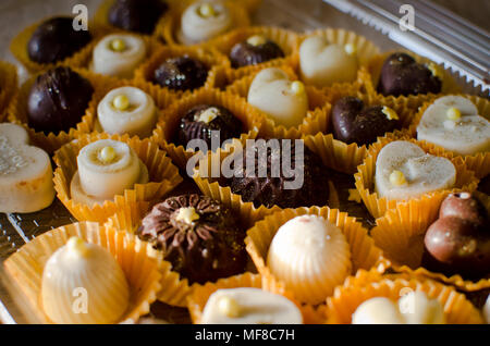 small brown and white chocolate handmade cakes in yellow paper baskets close up Stock Photo