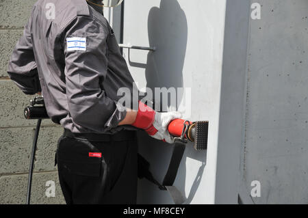 Fire fighter uses hydraulic tools to breach a locked door Stock Photo