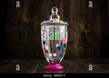 Colorful empty glass jar on wooden background Stock Photo