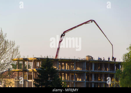 Concrete pouring during commercial concreting floors of buildings in construction. Stock Photo