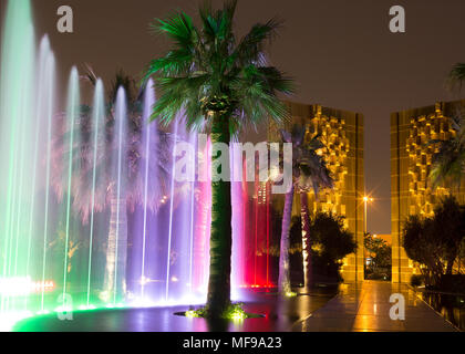 Al Shaheed Park, Kuwait. Night time fountain light show. Constitution monument in the background. Stock Photo