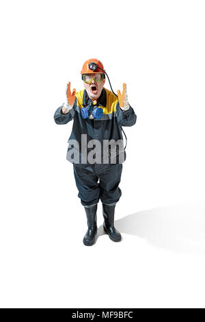 The studio shot of senior bearded male miner standing at the camera on a white background. Stock Photo