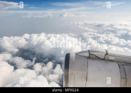 Slightly dirty airliner jet engine and cloudy sky, airplane in flight Stock Photo