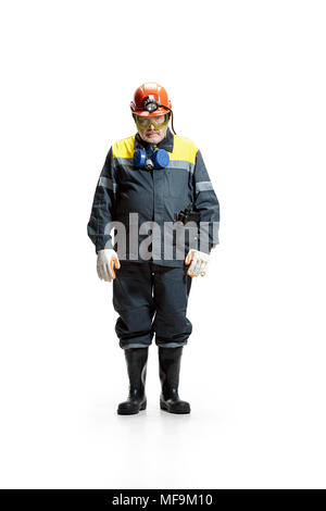 The studio shot of sad senior bearded male miner standing at the camera on a white background. Stock Photo
