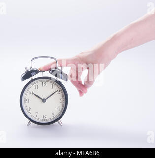 alarm clock with hand. alarm clock with hand on background. Stock Photo