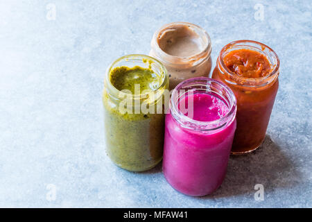 Jar of Beet Dip Sauce, Almond Butter or Tahini Pistachio Urbech and Salsa (Tomato Paste) Sauce. Organic Food. Stock Photo
