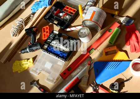 Set of hand tools on a wooden panel on the floor Stock Photo